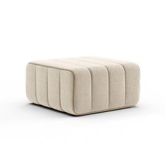 a beige ottoman sitting on top of a white floor