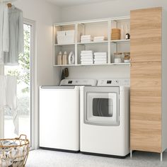 a washer and dryer in a room with open shelves on the wall next to each other