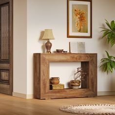 a living room with a wooden table and potted plant on the floor next to it