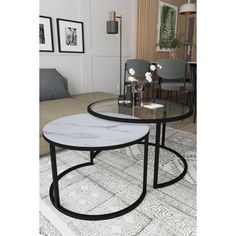 two tables sitting on top of a rug in a living room