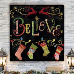 a christmas sign with stockings hanging from it's sides and the words believe written in large letters