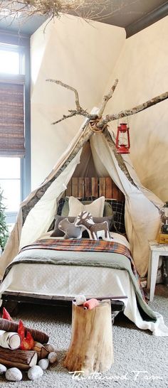 a bed in a room with a teepee tent