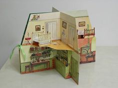 an open dollhouse with furniture and accessories on the inside, including a kitchen area