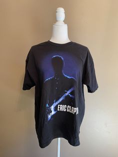 Vintage Eric Clapton "An Evening of Nothing But The Blues" t-shirt. Tag reads X-Large. See approx measurements below for size details. Pre-owned (used) vintage condition, light wear, light fading. 100% cotton.  Shoulder to shoulder: 21"  Shoulder to end of sleeve: 7"  Armpit to armpit: 22"  Back of neck to bottom: 25"   All of the items listed are pre-loved vintage pieces and will have varying degrees of wear, tear and patina. I do my best to describe and capture any noticeable flaws in the item description and photos (which are considered part of the description). Please review the information carefully to ensure I have not missed anything. If you have any questions about the item or would like additional photos, please let me know, I will be happy to answer your questions and provide add Blue Screen Print T-shirt For Concert, Blue Cotton T-shirt For Concert, Shirt Tag, Estes Park, Eric Clapton, The Blues, Vintage Pieces, Blue Tshirt, Patina