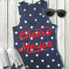 CHEERS MERICA Blue Stars Tank Top with Red Print Celebrate this 4th of July in this Patriotic AF Cheers Merica Tank Top! Sizes: XS, S, M, L, XL, 2XL Measure yourself, and use the size charts provided to determine the best size for you. Cotton Blend Super Soft and Comfy Patriotic Blue Tops For Summer, Blue Patriotic Tops For Summer, Blue Patriotic Summer Tops, Red Tank Top With Flag Print For Summer, Red Flag Print Tank Top For Summer, Summer Americana Crew Neck Top, Americana Crew Neck Tops For Summer, Blue Star Print Summer Tops, Americana Style Crew Neck Summer Tops