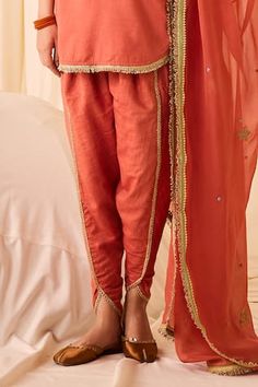 Peach kurta with thread zari embroidered floral motifs, embellished by tassels and kiran lace. Comes with tulip pant and dupatta. - Aza Fashions Anarkali Chanderi Pants For Eid, Traditional Designer Pants With Gota Work, Designer Chanderi Bottoms For Eid, Festive Designer Chanderi Bottoms, Resham Embroidered Anarkali Set For Puja, V-neck Chanderi Sets For Diwali, Designer Traditional Drape Bottoms For Eid, Festive Gota Work Sets With V-neck, Chanderi Pants For Wedding And Eid