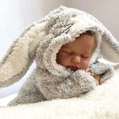 a baby wrapped in a bunny costume sleeping