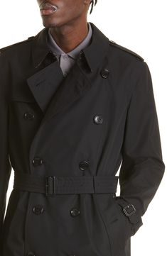 A classic double-breasted silhouette defines this mid-length trench crafted in the UK from water-repellent cotton gabardine and styled with a removable belt. Double-breasted button closure Notched lapels with hook-and-eye throat latch Belted cuffs Front button-welt pockets Gun flap Storm flap Back vent Removable belt Check-print lining 100% cotton Dry clean Made in the UK Men's Designer Clothing Classic Double-breasted Outerwear With Belted Cuffs, Classic Gabardine Belted Outerwear, Classic Gabardine Pea Coat, Classic Business Outerwear With Belted Cuffs, Classic Outerwear With Belted Cuffs, Belted Black Gabardine Outerwear, Black Belted Gabardine Outerwear, Classic Belted Pea Coat For Business, Classic Double-breasted Outerwear With Belt Loops