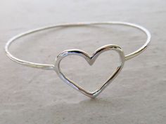 "Sterling Silver Heart Bangle~ Beautiful sterling silver heart bangle, custom made for you! Hammered and polished for that extra sparkle! Looks great worn with one or more! Perfect gift for Valentine's Day, Anniversary or Bridesmaid gift. Made with 14 gauge sterling silver wire Please view the last picture on this listing that shows how to measure for your correct size as there will be a charge for size exchange! For correct size measure the circumference of your hand with a tape measure around Hammered Bracelet, Bracelet Love, Wedding Accessory, Jewelry Bridesmaid, Love Anniversary, Bridesmaid Wedding, Sterling Silver Heart, Tape Measure, Bridesmaid Gift