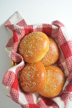 three buns sitting in a red and white cloth