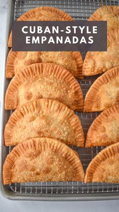 several empanadas on a cooling rack with text overlay that reads cuban style empanadas