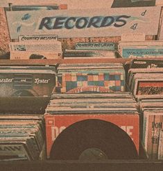 there are many records on display in the store and one has a record player next to it