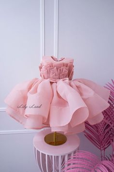 This beautiful blush tutu first birthday baby girl dress is the perfect choice for any little princess's special day. Crafted from high-quality tulle fabric, this puffy dress is designed to provide a comfortable and stylish fit for your little one. Whether she's attending a first birthday party or serving as a flower girl, this dress is sure to make a statement. The delicate floral embellishments and elegant design create a stunning and sophisticated look that will have everyone talking. Your li Elegant Pink Tutu Dress For Wedding, Elegant Pink Baptism Dress For Spring, Pink Organza Tutu Dress For Baptism, Elegant First Birthday Tulle Tutu Dress, Organza Tutu Dress With Ruffles For First Birthday, Elegant Tulle Princess Dress For First Birthday, Elegant Ruffled Princess Dress For Birthday, Pink Organza Princess Dress With Ruffles, Elegant Pink Tulle Princess Dress