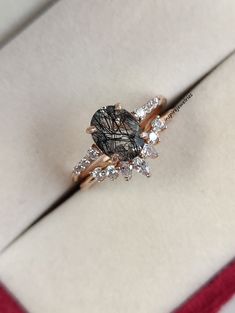 a diamond ring sitting on top of a white box