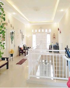 a living room filled with furniture and lots of plants