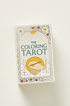 the coloring tarot book is sitting on top of a white surface with an orange flower