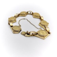 This is part of Chairish’s Fine Jewelry assortment.  A beautiful 14k yellow gold bracelet from the Etruscan Revival period, circa 1880. The bracelet is exquisitely hand-made and is a fine example of cannetille gold work, which is similar to filigree work with fine gold wires that curl around thinly hammered sheets. Cannetille gold work was inspired by embroidery and nature. The repeating curling designs on each segment of the bracelet are harmonious and elegant. The diamond shape of the segment Antique Yellow Gold Bracelet For Formal Occasions, Antique Yellow Gold Bracelets For Formal Occasions, Antique Yellow Gold Jubilee Bracelet, Victorian Yellow Gold Bracelet For Formal Occasions, Formal Yellow Gold Brass Bracelets, Heirloom Yellow Gold Jubilee Bracelet, Ceremonial Engraved Yellow Gold Bracelet, Heirloom Yellow Gold Bracelet With Filigree, Heirloom Yellow Gold Filigree Bracelet