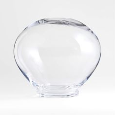 a clear glass vase sitting on top of a white table