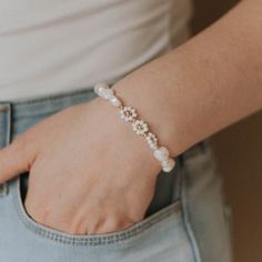 Delicate and feminine, our Eva Bracelet is the perfect everyday piece. Featuring 8mm freshwater pearls framed with our golden white daisies, this bracelet will make you feel confident and absolutely sparkle. Materials: A mix of 8 mm freshwater pearls, white glass seed bead daisies, 3 mm & 4 mm gold filled bead accents Elegant Flower Bracelets For Everyday, Elegant Everyday Flower Bracelets, White Flower Bracelets For Everyday, Delicate White Pearl Bracelet For Everyday, Summer White Pearl Bracelet, Adjustable White Beaded Feminine Bracelets, White Pearl Bracelet For Everyday, Everyday White Pearl Beaded Bracelets, Feminine White Pearl Bracelet As A Gift