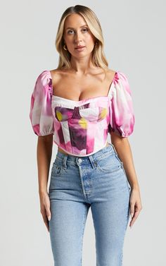 Feel like the life of the party in our Lucienna Top - Sweetheart Blouson Puff Sleeve Corset! This stunning pink bodysuit is designed to make you stand out on any occasion, whether it's a night out with friends or a special event. With its sweetheart neckline and 3/4 puff sleeves, this top adds a touch of femininity and elegance to your outfit. Made from high-quality polyester, it offers both comfort and durability. Pair it with your favorite jeans or skirt for a fun and fashionable look that wil Feminine Pink Corset With Sweetheart Neckline, Pink Feminine Corset With Boned Bodice, Pink Corset With Sweetheart Neckline For Spring, Pink Sweetheart Neckline Corset For Spring, Pink Boned Bodice Corset, Pink Fitted Corset With Sweetheart Neckline, Spring Party Crop Top With Puff Sleeves, Spring Pink Fitted Corset, Pink Fitted Corset For Spring