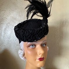 This Is A Beautiful Sample Of The Elegant Millinery Fashions Of The 1940s'. It Consists Of A Round Felt Structure In The Shape Of A Doughnut (Without The Hole), With An Attached Grosgrain Band At The Back To Hold The Hat In Place. The Top Of The Hat Is Beautifully Trimmed With Shiny Black Curled Strips, As Photographed. The Center Top Of The Hat Has Black Veiling That Wraps Around A Tall Black Feather Spray. Simply Gorgeous! Tilt Hats Were Popular In The 1930s And 1940s. They Were Worn At An Ang Black Curls, Back Of The Head, Colorful Feathers, Black Felt, Black Feathers, Black Trim, Fashion History, Hats Vintage, Elastic Band