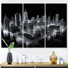 three panels of cityscape in black and white on a wall above a dresser