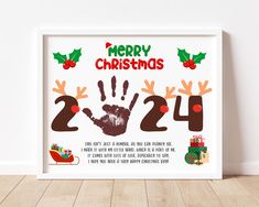 a white framed christmas card with handprints on it