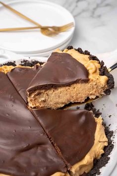 a chocolate peanut butter pie is cut in half