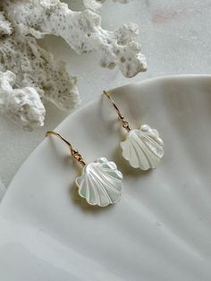 Welcome to SeashellandStoneco These adorable earrings feature Mother of Pearl shells, bringing a touch of the ocean to your style. The delicate shell design adds a lovely, natural shimmer that's perfect for any occasion. Lightweight and easy to wear, they're a sweet to brighten up your day! MATERIAL 14K Gold-Filled Jewelry Ball End Ear Wire   Size : 11.5 × 20mm Mother of Pearl Charm Size : 13 × 12mm AROUT 14K GOLD-FILLED JEWELRY 14K gold-filled jewelry contains 5% solid gold. The gold layer is p Elegant Nickel-free Shell Jewelry, Elegant Shell-shaped Summer Jewelry, Elegant Summer Shell-shaped Jewelry, Elegant Nickel-free Shell Earrings, Elegant Summer Jewelry With Shell Design, Elegant Shell Jewelry For Summer, Elegant Summer Shell Jewelry, Elegant Shell-shaped Jewelry With Ear Wire, Ocean-inspired Shell-shaped Earrings For Gifts