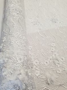 This Beautiful 3D Embroidered Satin Floral Pearl fabric is one of a kind. The fabric is backed with a mesh fabric and a gorgeous embroidered floral design, that gives off a 3D illusion. There are Pearls that have been stapled on to the fabric to give a gorgeous and eye catching design. Fabric is sold by the yard and if more than one yard is purchased, it will come in one piece. White satin is used for the backing of the fabric in images only, not included in the fabric. Width: 52" Uses: Apparel, Elegant Floral Embellished Lace Fabric, Elegant Floral Embroidered Net Fabric, Elegant Lace Fabric With 3d Embroidery, Intricately Embroidered Fitted Fabric For Mother Of The Bride, Fitted Embroidered Fabric For Mother Of The Bride, Floral Embellished Lace Fabric In Flower Shape, Floral Embellished Lace Embroidered Fabric, Lace Embroidered Floral Fabric, Elegant Organza Fabric With 3d Embroidery