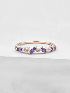 This cluster ring is encrusted with a series of round, oval and pear shaped cubic zirconia stones. The ring is made of gold plated brass. Ring is about 3 mm in height. Stones cover only half of the band. The Cubic zirconias are amethyst colored. This stacker is perfect as a fashionable piece to enhance your outfit or wear as a placeholder for your engagement ring or wedding band! Please read my shop policies to learn more about the composition and proper care for each item purchased. All plated Amethyst Cluster Ring, Purple Promise Ring, Purple Sapphire Wedding Ring, Purple Rings Engagement, Engagement Rings Purple, Purple Wedding Ring, Amethyst Engagement Rings, Purple Engagement Ring, Trend Rings