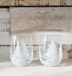 two wine glasses sitting on top of a table