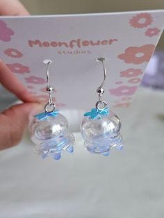 These cute jellyfish earrings are a delightful and whimsical accessory that add a touch of playful charm to any outfit. These earrings are crafted from high-quality materials such as sterling silver, gold-plated metal, or acrylic, and feature intricate detailing to resemble the graceful and otherworldly beauty of jellyfish. Drop Length: 3 inches material: sterling silver, jelly head (acrylic) Quantity: 2 pieces / 1 pair DISCLAIMER: Handcrafted Nature: Handmade jewelry is crafted by me and may ha Jellyfish Earrings, Otherworldly Beauty, Cute Jellyfish, Moon Jellyfish, Whimsical Accessories, Earrings Moon, Earring Dangle, Etsy Earrings Dangle, Elegant Jewelry