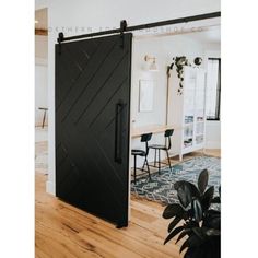 a black sliding door in the middle of a room