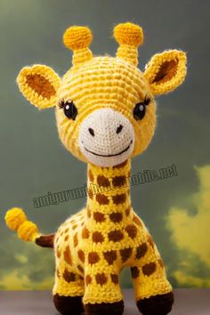 a crocheted giraffe stuffed animal sitting on top of a table