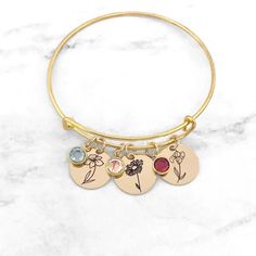 Birth Flower Bracelet • Birthstone Bracelet • Birth Month Flower Bracelet • Personalized Birth Flower Bracelet • Gift For Mom Have this bangle bracelet personalized with the birth flower(s) and birthstone(s) of your choice! Personalized jewelry makes the perfect gift for so many occasions. Each Adjustable Flower-shaped Charm Bracelets, Adjustable Flower-shaped Bracelets With Charms, Adjustable Flower Charms Bracelets, Personalized Flower Jewelry For Friendship, Personalized Flower Shaped Friendship Jewelry, Personalized Flower-shaped Jewelry For Friendship, Personalized Flower-shaped Friendship Jewelry, Adjustable Bracelet With Flower Charm, Adjustable Crystal Bracelet With Flower Charm