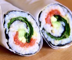 two sushi rolls are sitting on a table