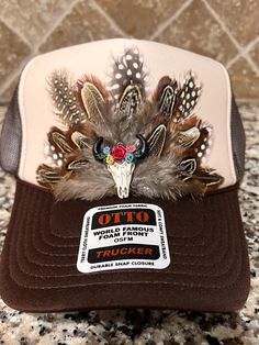 Feathered Trucker Hat. Each feather individually placed by hand on the hat, therefore all hat designs and patterns will vary, making each hat unique and 1 of a kind! **WARNINGS** *Keep away from children and pets. The Freshiry is NOT RESPONSIBLE for any damages or injuries due to misuse. SOCIALS: Add our shop to your favorites!  Follow us on our FB, Instagram and TikTok pages @the_freshiry for updates on new products! POLICIES: All products are FINAL sale, but should you have an issue, please contact us within 2 days of delivery of your order and I will do my best to resolve it. Note: Products are handmade and may have slight imperfections.  The Freshiry is NOT RESPONSIBLE for any damages or injuries due to misuse. To view our entire policies, please click here: https://www.etsy.com/shop/t Brown Trucker Hat For Western-themed Events, Western Style Trucker Hat For Beach, Western Beach Trucker Hat, Western Style Summer Festival Trucker Hat, Western Style Trucker Hat For Summer Festivals, Country Style Snapback Trucker Hat For Western Events, Country Style Trucker Hat For Western-themed Events, Country Style Festival Trucker Hat, Brown Western Mini Hat