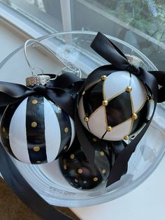 two black and white ornaments in a clear bowl