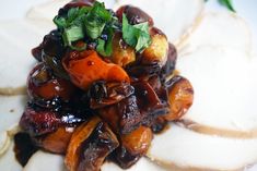 a close up of food on a plate with sauce and vegetables in the middle,