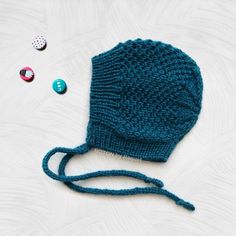 "❤️ 𝗗𝗘𝗧𝗔𝗜𝗟𝗦 This teal winter toddler bonnet hat is perfect for your little one stay warm and stylish through the cold days! A handmade bonnet hat with a simple, yet lovely, pattern that your toddler will love to wear. This kids knit hat closes tightening a bow with the crochet ribbon around your kid's neck. ⭐️ 𝗙𝗘𝗔𝗧𝗨𝗥𝗘𝗦 - Handmade knit bonnet - Season: WINTER - Yarn (100% acrylic) - Colour: pick your favorite color from the \"select a color\" option. The color chart is in the pictures above. - Production Method: Knit - ID number: NGB0574 - Sizes (measure the circumference around the head): 2-3 years: 19-20\" (48-50cm) 3-5 years: 20-20,5\" (50-52cm) 5-8 years: 20,5-22\" (52-56cm) ✈️ MADE TO ORDER: one item has a processing time of 4 to 6 weeks --------------------------------- Adjustable Knitted Bonnet, Playful Warm Bonnet Cap, Handmade Winter Bonnet As A Gift, Handmade Winter Bonnet As Gift, Handmade Winter Bonnet Gift, Handmade Playful Winter Bonnet, Playful Handmade Winter Bonnet, Handmade Winter Bonnet Cap, Handmade Adjustable Beanie Bonnet