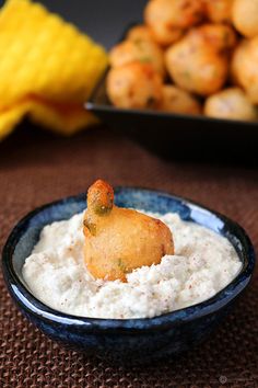 a bowl filled with white rice and a fried chicken nuggie on top of it