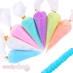 six different colored cotton cones with tooth picks in them on a white background next to an ice cream cone