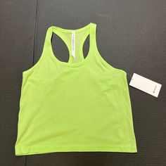 a bright green tank top with a white tag on it