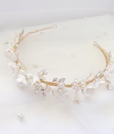 Add a perfect finishing touch to your bridal look with this elegant headband. ... i n f o  +  d e t a i l s ... - metal headband (40cm long) - 30 cm of detailing - ceramic white flowers, faux pearl and faux rhinestone details  .... p l e a s e . n o t e ... As our items are handmade, there may be slight variances in sizing and fabrication between items and example images shown. Please note, there may also be slight color variances from images shown due to screen settings, photography, and materi Boho Bride Hair, Flower Bride, Elegant Headband, Headband Boho, Bride Headband, Metal Headband, Bride Headpiece, Unique Bride, Bride Hair