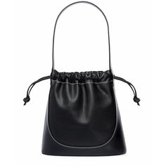 a black leather handbag on a white background with the handle down and an empty tag hanging