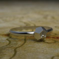 a close up of a silver ring on a table cloth with an animal motif in the background