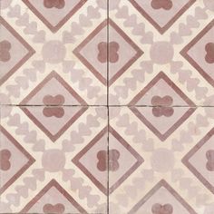 an old tiled floor with brown and white designs on it's sides, including hearts