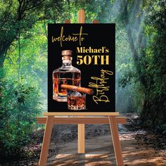 an easel with a bottle of alcohol on it and a sign that says welcome to michael's 50th birthday