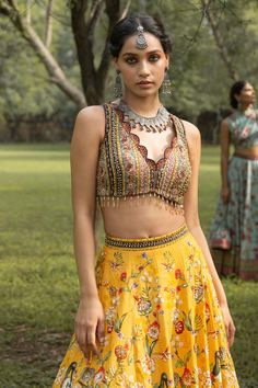 Yellow lehenga with all-over floral print and delicate embellishments. Comes with embroidered sleeveless blouse and soft net aqua dupatta in chitta work.
Component: 3
Printed, Embroidered
Neckline: V-Neck
Sleeve Length: Sleeveless
Fabric: Dola Silk
Color: Yellow 
Embroidered blouse with beaded tassels
Scallop edged neckline and lehenga hem
Printed and embroidered dupatta border
Tie-up at the back
 - Aza Fashions Dupatta Border, Printed Lehenga, Yellow Lehenga, Indian Saree Blouse, Indian Saree Blouses Designs, Embroidered Dupatta, Embroidered Neckline, Silk Embroidery, Fashion App